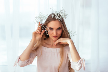 Spring and summer portrait of a young woman in flowers.