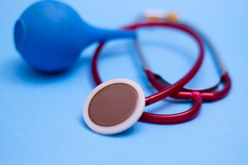 Medical stethoscope and syringe on a blue background. Medical instruments. Place for your text. Medical background