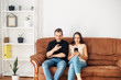 © Face Stock - A young couple on the couch look at the phones