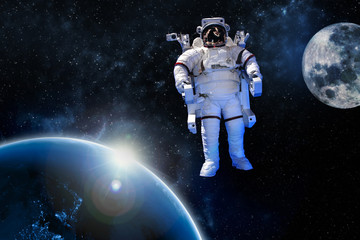 Wall Mural - astronaut float in the space in weightlessness near to planet earth