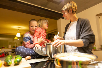 Mother and daughter having fun in the kitchen during cooking