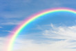Rainbow and blue sky with clouds background