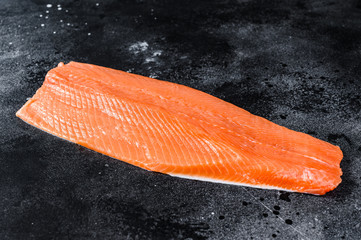 Wall Mural - Raw salmon fillet. Organic fish. Black background. Top view. Copy space