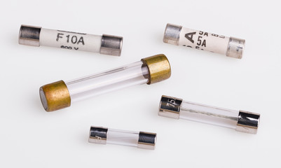 Set of miniature electrical fuses for overcurrent protection in electronics. Safety electronic components group. Metal fusible wire or strip between two terminals enclosed in ceramic or glass tubes.