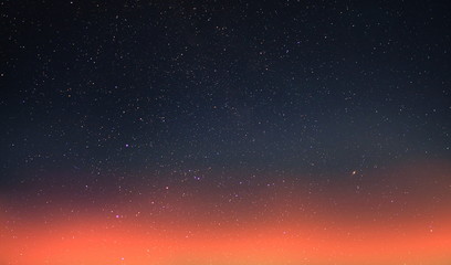 Wall Mural - starry sky and orange sunset summer night cloudy seascape nature background weather forecast