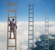 © Elnur - Young businessman climbing career ladder