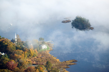 Wall Mural - Aerial view of fog in autumn over islands and hills north of Portland Maine