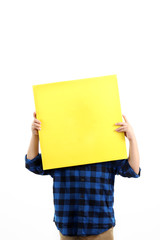 Cheerful little asian boy holding a yellow canvas board isolated on white background