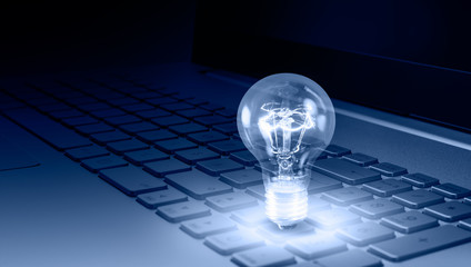 Closeup light bulb on keyboard laptop - New ideas Concept