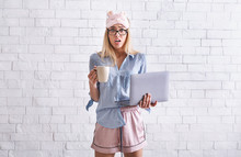 Work From Home. Girl In Pajamas, Sleep Mask With Cup And Laptop