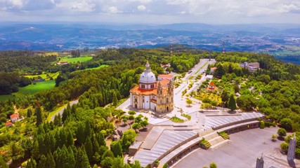 Wall Mural - Braga, Portugal. Aerial view of Sameiro Sanctuary in Braga, Portugal during the sunny day. Panning time-lapse of popular landark with nature around it