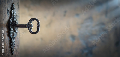 Fotografía Old key in keyhole, macro shot