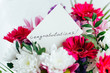 white card for a bouquet with the inscription congratulations in a bright beautiful bouquet of flowers