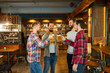 © Studio Romantic - Group of happy friends clinking glasses with beer at a sports bar.