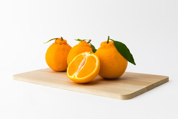 Cross section with fresh orange Hallabong on white background. Fruit seen from the front. (Korea, Jeju Island specialties)