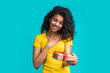 © wpadington - Attractive young african american woman with gift box in hands