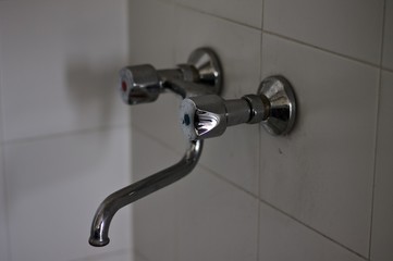 Old metallic water tap with knobs (Pesaro, Italy, Europe)