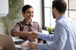 © fizkes - Happy multiracial businesspeople shake hands at meeting greeting getting acquainted, smiling diverse business partners handshake close deal make agreement after successful negotiation or briefing