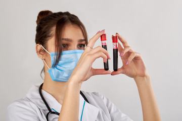 Portrait of doctor with two blood test samples. Isolated on white background.