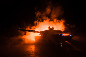 War Concept. Armored vehicle silhouette fighting scene on war foggy sky background at night.