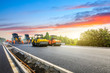 © ABCDstock - Construction site is laying new asphalt road pavement,road construction workers and road construction machinery scene.highway construction site landscape.