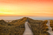 Wooden Path And Stairs Crossing The Dunes To The Beach Of Norddorf, Amrum, In Sunset
