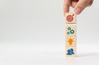 Concept of business strategy and action plan. Hand putting wooden cube block stacking with icon on white background