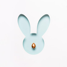 Hole Easter Bunny Face Made Of Cut Paper And Golden Egg Nose. Happy Easter Minimal Concept In Pastel Colors