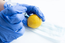 Hands Of A Doctor Make An Injection In Lemon.