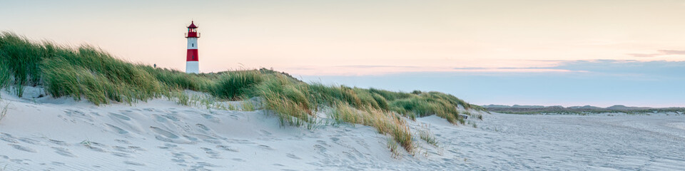Wall Mural - panoramic view of a lighthouse standing at the coast of sylt, north sea, germany