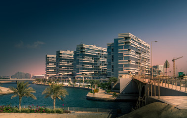 man made island with residence and commercial buildings at al raha creek with beautiful waterfront c