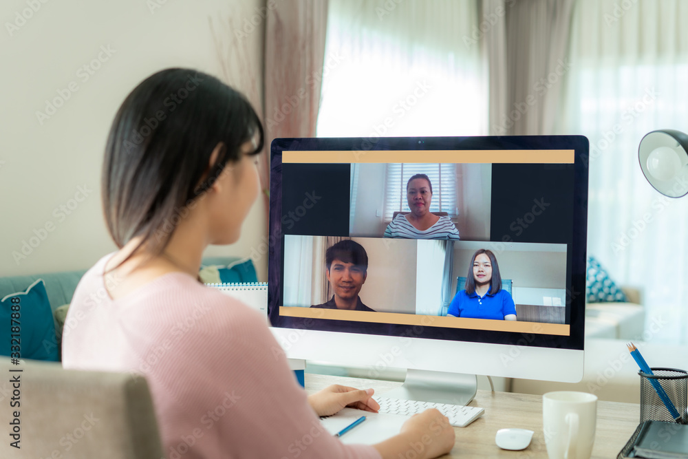 Asian business woman talking to her colleagues about plan in video conference. Multiethnic business team using computer for a online meeting in video call. Group of people smart working from home.. - obrazy, fototapety, plakaty 
