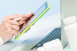 © Nana_studio - Doctor's hand uses a laptop and digital tablet on a blue background. medicine concept, modern technology