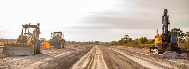 a new road is under construction with several pieces of heavy equipment