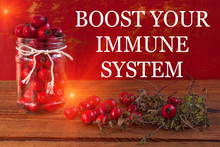 Boost Your Immune System Text Banner. Immunity Boosting Treatments. Natural Thyme, Mint Herb, Rosehip Berries In Jar On Wooden Background. Virus Phyto Therapy Remedies.Cold Flu Ethnoscience,homeopathy