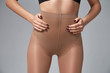 Part of woman body perfect shape hips legs skin tan wear stockings, nylons, pantyhose lingerie hosiery hose studio shot on white background.