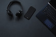 © Miha Creative - Laptop, phone,  watch,  sunglasses over monochrome black  background. Work accessories of a blogger with copy space and top view. Minimalist black  trendy, Flat Lay