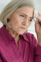 Canvas Print - Close up portrait of sad ill senior woman