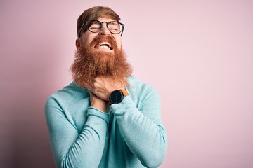 Wall Mural - Handsome Irish redhead man with beard wearing glasses over pink isolated background shouting suffocate because painful strangle. Health problem. Asphyxiate and suicide concept.