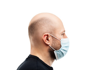 Wall Mural - Young adult bald head man wearing respiratory protective medical mask