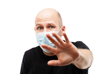 Young adult bald head man wearing respiratory protective medical mask