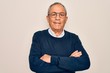 © Krakenimages.com - Senior handsome grey-haired man wearing sweater and glasses over isolated white background happy face smiling with crossed arms looking at the camera. Positive person.
