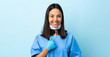 Surgeon woman over isolated blue background with surprise facial expression