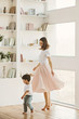 © Olena Bloshchynska - Beautiful mother and cute little son are dancing together at home.