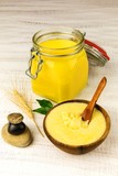 Fototapeta  - Ghee or clarified butter in jar. Healthy eating and using organic fresh made products. Healthy ingredient for cooking organic meal.Spoon with ghee butter