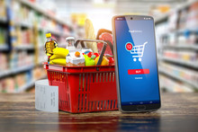 Shopping Basket With Fresh Food And Smartphone. Grocery Supermarket, Food And Eats Online Buying And Delivery Concept.