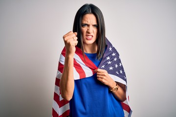 Wall Mural - Young brunette patriotic woman with blue eyes wearing united states of america flag annoyed and frustrated shouting with anger, crazy and yelling with raised hand, anger concept