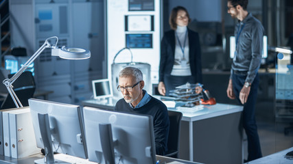 Fototapete - Diverse International Team of Industrial Engineers and Scientists Working in Research Laboratory / Development Center. People Working on New Efficient Engine Concept Design. Professionals Teamwork