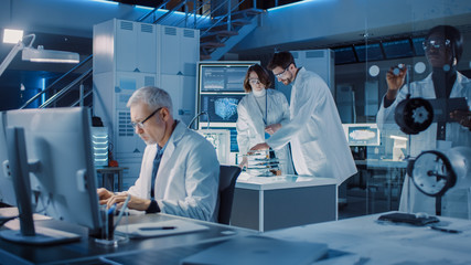 Poster - Diverse International Team of Industrial Scientists and Engineers Wearing White Coats Working on Heavy Machinery Design in Research Laboratory. Professionals Using Computers and Talking