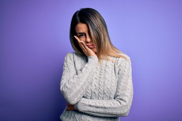 Wall Mural - Young beautiful woman wearing casual sweater standing over isolated purple background thinking looking tired and bored with depression problems with crossed arms.